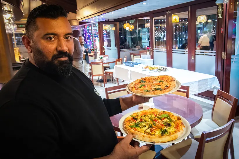 Chef with pizzas at Gill's Restaurant Gibraltar